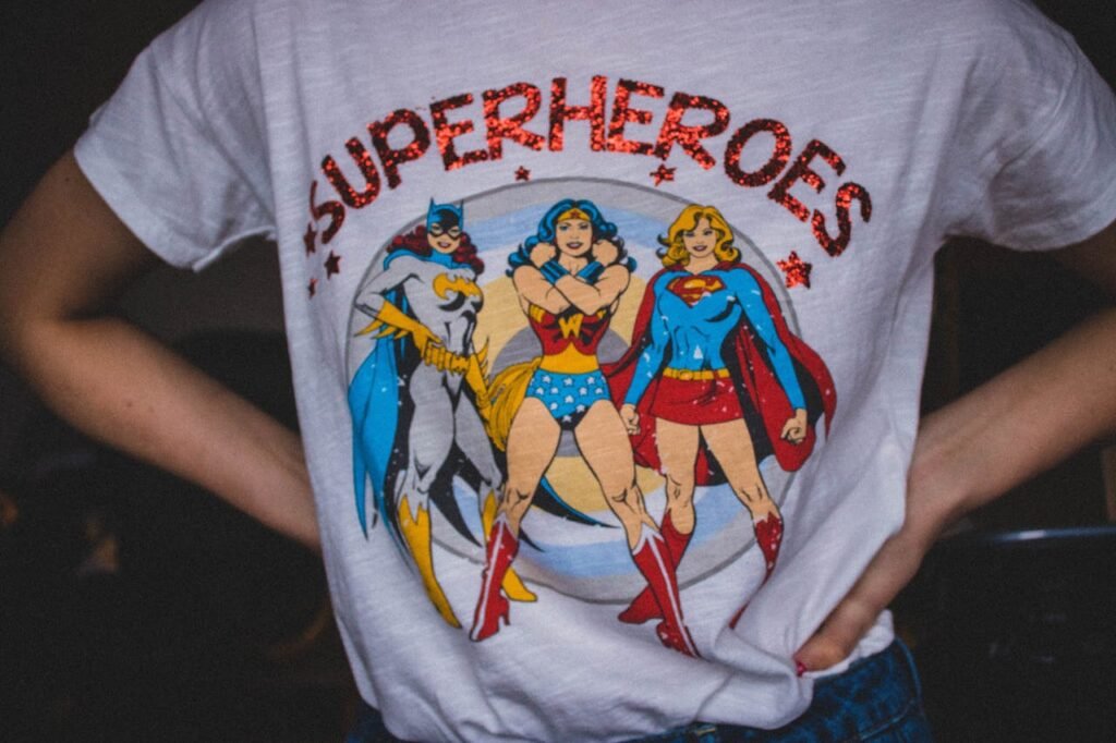 A vibrant superhero themed t-shirt featuring female comic characters in a bold design.
